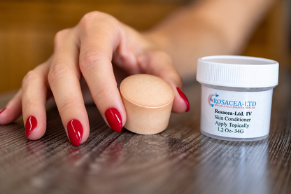 Hand holding a brown ROSACEA-LTD mineral disc beside its labeled skin conditioner jar.